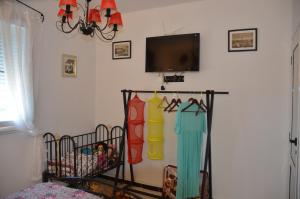 a living room with a tv and some hangers at Mostaganem kharrouba apartment f3 in Mostaganem