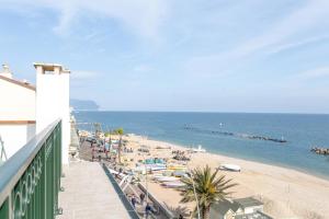 a view of a beach with people and the ocean at Affittacamere Prima Fila Mare in Porto Recanati +15 photos