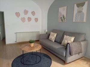 a living room with a couch and a table at Apartamentos La Machacona Plaza Mayor recién reformados in Cáceres