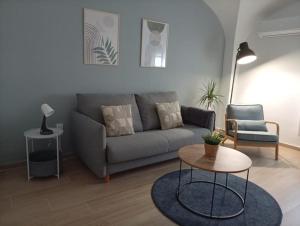 a living room with a couch and a table at Apartamentos La Machacona Plaza Mayor recién reformados in Cáceres