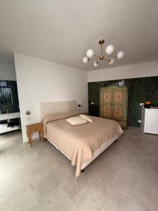 a bedroom with a bed and a chandelier at Casa Elisa in Capri