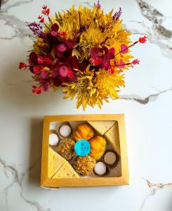 a box of muffins and a vase with flowers at Hotel Lince in Lima +12 photos
