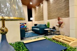a lobby with a couch and a tv in a room at Bherunda Mount Resort in Kegalle