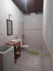 a white bathroom with a sink and a toilet at Casa El molinito in Chilecito