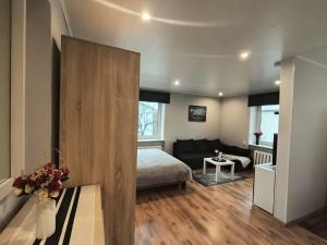 a bedroom with a bed and a large wooden door at Central Haapsalu Apartment in Haapsalu