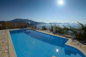a swimming pool with a view of the ocean at Eleonora Villa in Évyiros