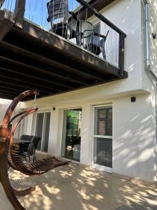 a balcony with a bench on a house at Sun&Fun Vendégház in Balatonakarattya