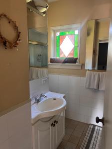 a bathroom with a sink and a mirror and a window at Sunset Ocean Retreat in West Vancouver +31 photos