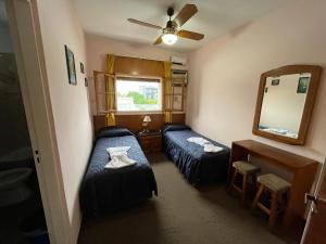 ein kleines Zimmer mit zwei Betten und einem Spiegel in der Unterkunft HS House in La Rioja