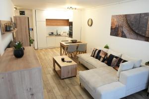 a living room with a couch and a table at StarLux Residence - Because you deserve it! in Ćuprija