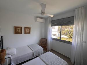 a bedroom with two beds and a window at Terraza Montaña in Nerja