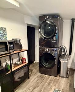 a kitchen with a washing machine and a microwave at Artsy Platt Park Apartment Guest Suite for 4, QUICK Mountain Access! in Denver