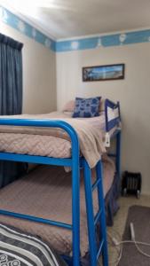 a bedroom with two bunk beds in a room at Raglan Vista in Raglan
