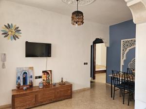 a living room with a tv on a wall at Pearl studio avec terrasse in Larache