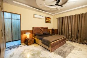 a bedroom with a bed and a large window at Kubn Retreat in Chandigarh Airport +8 photos
