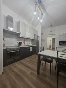 a kitchen with a table and a dining room at Danito Rooms 3 singola in Ancona