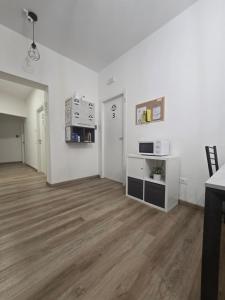 an empty living room with white walls and wood floors at Danito Rooms 3 singola in Ancona +9 photos