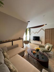 a living room with a couch and a table at Valena 2 - Divčibare Free private Parking in Divčibare