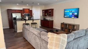 a living room with a couch and a kitchen at Charming townhouse ideally situated in Grayson in Grayson