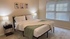 a bedroom with a large bed and a window at Charming townhouse ideally situated in Grayson in Grayson
