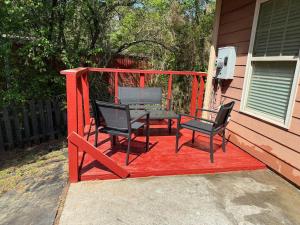 a deck with two chairs and a table on a house at Charming townhouse ideally situated in Grayson in Grayson