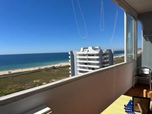 a room with a large window with a view of the beach at Estúdio Azul-T0-Torralta-Ocean View by Aura in Alvor