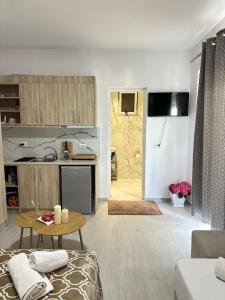 a living room with a table and a kitchen at Villa Adi Saranda in Sarandë +38 photos