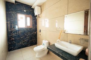 a bathroom with a sink and a toilet at 2Kubn retreat in Chandigarh Airport