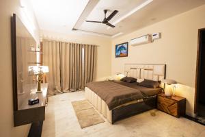 a bedroom with a bed and a ceiling fan at 2Kubn retreat in Chandigarh Airport