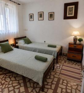 a bedroom with two beds and a dresser at Nina Apartments in Negotin