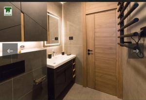 a bathroom with a sink and a wooden door at Maksim 2 in Iglići