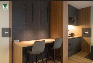 a kitchen with a counter and two stools in it at Maksim 2 in Iglići +15 photos