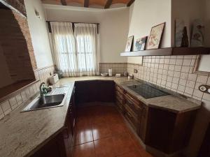 a kitchen with a sink and a counter top at Casa Rural Parajes del Júcar in Casas de Benítez