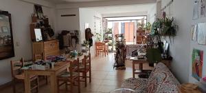 a woman standing in a room with tables and chairs at La Salvaje Bazar Mágico in Yucay