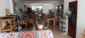 a room filled with lots of tables and potted plants at La Salvaje Bazar Mágico in Yucay