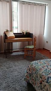 a bedroom with a piano and a bed and a chair at La Salvaje Bazar Mágico in Yucay