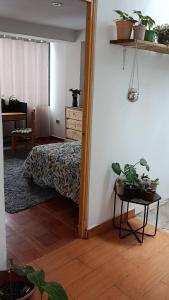 a bedroom with a bed and a table with a mirror at La Salvaje Bazar Mágico in Yucay