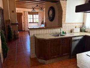 a kitchen with a sink and a counter top at Casa Rural Parajes del Júcar in Casas de Benítez