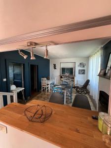 a kitchen and living room with a table and chairs at Maison de Georges et Paulette in Bouesse