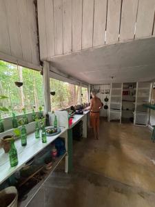 a man is standing in a kitchen in a trailer at A Casa Da Ilha Cotijuba in Belém