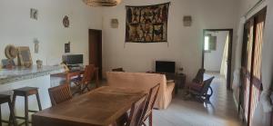 a living room with a couch and a table at Belle maison dans résidence avec piscine in Cap Skirring