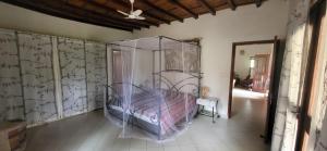 a bedroom with a bed in the corner of a room at Belle maison dans résidence avec piscine in Cap Skirring
