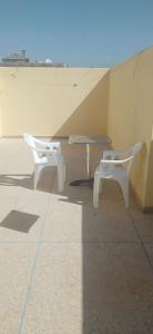 two white chairs and a table on a roof at دار للكراء التضامن in Taroudant