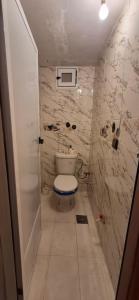 a small bathroom with a toilet and a sink at Panoramic House - Midelt Family Triplexe in Midelt