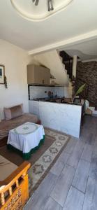 a living room with a couch and a kitchen at Panoramic House - Midelt Family Triplexe in Midelt