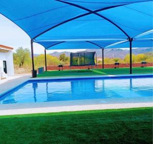 a large blue canopy over a swimming pool at Glamping in Pueblo Magico Alamos Sonora in Álamos