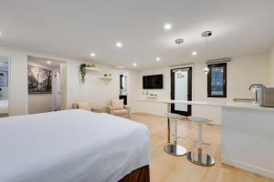 a bedroom with a bed and a kitchen with a counter at Classic King Size Guest Suite with AC in Burnaby