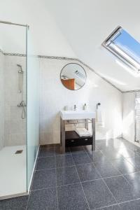 a bathroom with a sink and a shower and a mirror at Casa das Eiras, Nº48 in Santana +17 photos