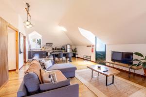 a living room with a couch and a table at Casa das Eiras, Nº48 in Santana