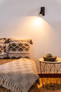 a bedroom with a bed and a table with a lamp at Casa das Eiras, Nº48 in Santana